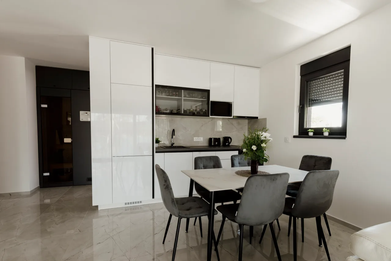 A bright kitchen and dining area with a table set for four